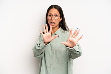 hispanic pretty woman feeling terrified, backing off and screaming in horror and panic, reacting to...