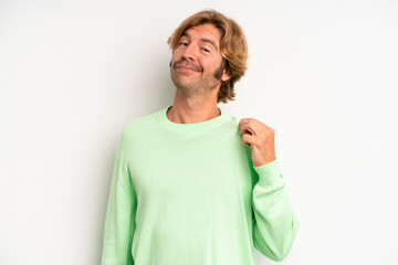 blond adult man looking arrogant, successful, positive and proud, pointing to self