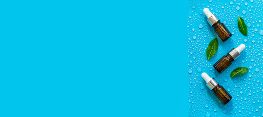 Bottle of cosmetics and drops of liquid, moisturizing. Hyaluronic acid. Selective focus.