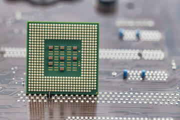 A large square microprocessor for computers lies on motherboard