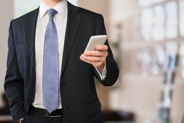 Joyful guy holding modern smartphone, looking at gadget screen, online, texting girlfriend