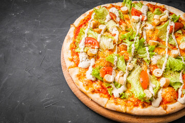 hot delicious traditional italian pizza on a dark stone background