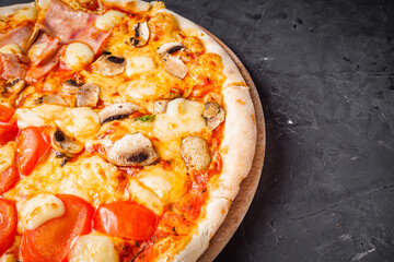 hot delicious traditional italian pizza on a dark stone background