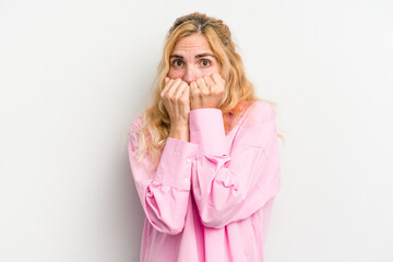 Young caucasian woman isolated on white background biting fingernails, nervous and very anxious.