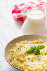 fresh tasty mashed potatoes on a white wooden rustic background