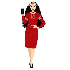 Beautiful young woman in traditional Ukrainian dress with a smartphone in her hand