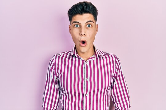 Young hispanic man wearing casual clothes afraid and shocked with surprise and amazed expression, fear and excited face.
