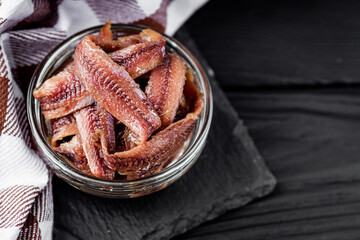 canned anchovy fillet on a black wooden rustic background