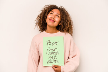 Young African American woman holding a bio placard isolated on white background dreaming of achieving goals and purposes