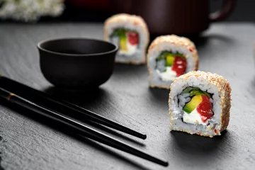 Fotobehang Roll with fish sushi with chopsticks. Philadelphia Roll . Japanese kitchen, restaurant. © vigenmnoyan