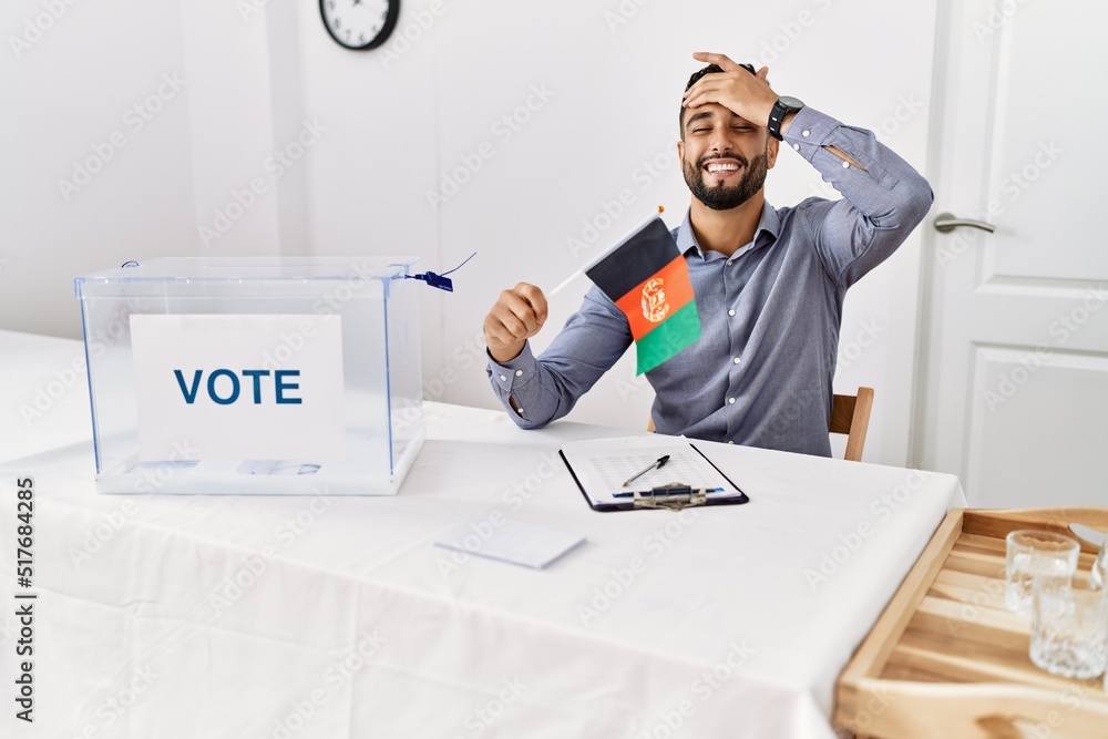 Sticker young handsome man with beard at political campaign election holding afghanistan flag stressed and f