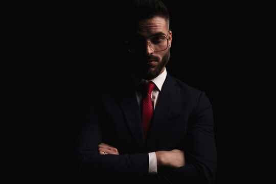 sexy bearded businessman in suit with eyeglasses crossing arms