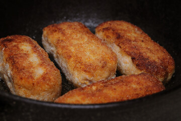 delicious delicious minced meatballs are fried in a frying pan