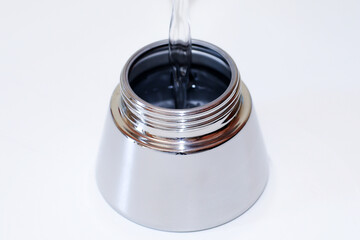 Homemade preparation of coffee with mocha. 
Step one - Fill the tank with water, taking care not to exceed the level of the relief valve.