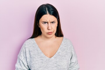 Fototapeta premium Young hispanic woman wearing casual clothes skeptic and nervous, frowning upset because of problem. negative person.