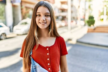 Caucasian teenager girl smiling happy standing at the city.