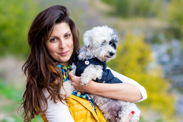Beautiful Young Woman Hugging  Her White Havanese  Dog Outdoor in the Mountain .Pet and Owner Outdoor 