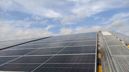 photovoltaic solar panels mounted on building roof for producing clean ecological electricity at...