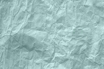 High detail of the abstract texture of the packaging paper. The texture of crumpled craft paper in pastel color. Crumpled paper background top view. The texture of crumpled paper. Space for text.