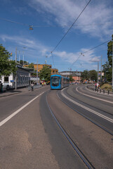 Tram for the Skansen stop leaving the Abba museum and Tivoli platform a sunny day in Stockholm
