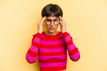 Young caucasian woman with a short hair cut isolated having a head ache, touching front of the face.