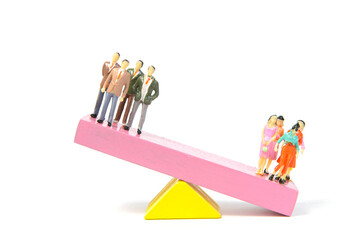 The balance between men and women on seesaw wooden blocks. Depicted in a conceptual image by a seesaw showing the male and female genetic symbols in equilibrium. 
