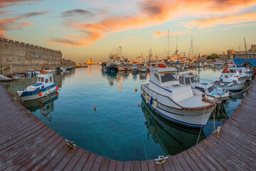 Fototapeta na wymiar Yachts and boats in picturesque port Mandraki marina, Rhodes, Greece