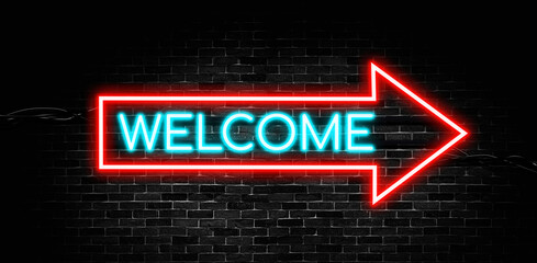Welcome neon banner with arrow shape on brick wall background.