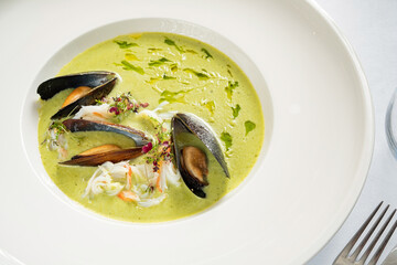 cream soup with mussels and herbs