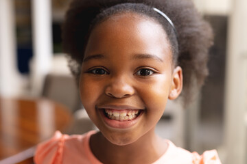 Image of happy african american girl looking at camera