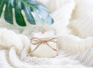 Handmade soy wax candle with green leaves