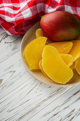 delicious dried mango on a white wooden rustic background