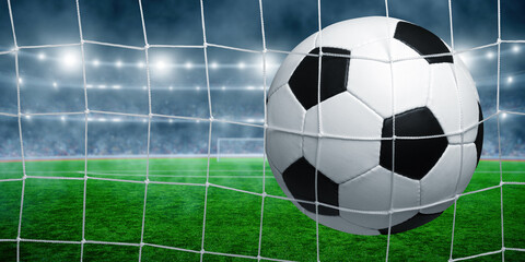 Soccer ball in goal on stadium