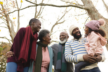 Image of happy african american multi generation family in autumn garden - Powered by Adobe