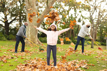 Image of happy african american multi generation family having fun in autumn garden