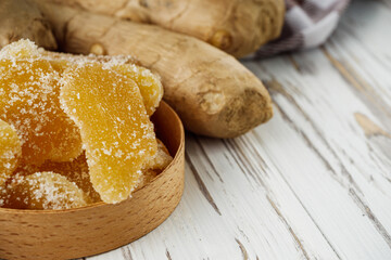 spicy dried ginger on a white wooden rustic background