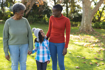 Image of happy african american three generation women in garden