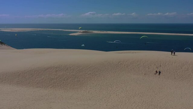  Paragliders fly over the Dune of Pilat ,Dune du Pilat , Arcachon, France. Largest sand dune in Europe.
