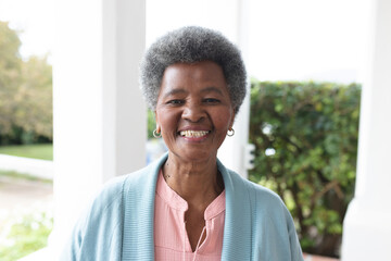 Image of happy african american senior woman posing at camera