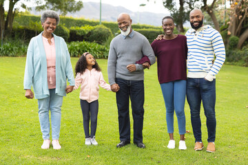 Image of happy multi generation african american family posing together outdoors - obrazy, fototapety, plakaty