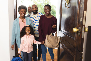 Image of happy multi generation african american family entering house
