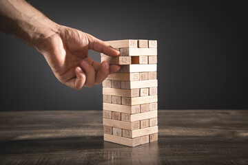 Male hand take one block. Risk. Business