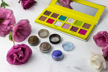 A palette of shadows in a bright yellow palette. Make-up table. Professional cosmetics