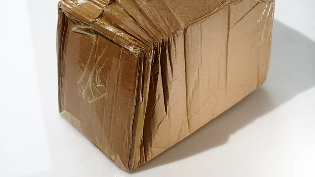 crumpled parcel cardboard box pasted over with adhesive tape from China