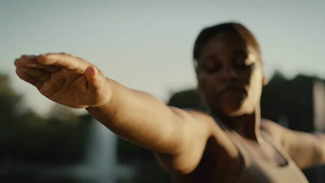 African American woman practicing yoga exercise at the park. Shot with RED helium camera in 8K.    