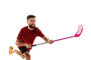 Dynamic portrait of male floorball player with floorball stick in action isolated on white background. Sport, competition and motion, movement, active lifestyle