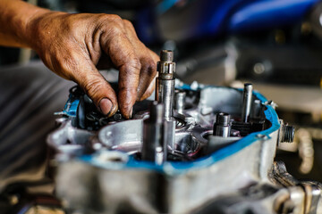 Maintenance and fix repair gear engine hand of technician close up