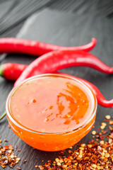 sweet chili sauce on a black wooden rustic background