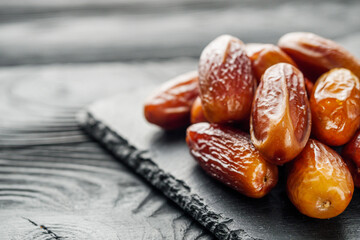 juicy royal dates on a black wooden rustic background