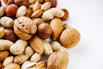 set of different nuts on a white acrylic background
